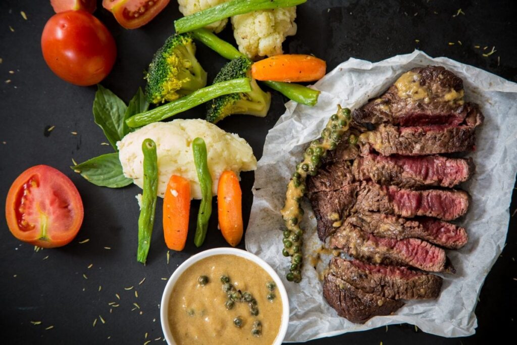 A Heart healthy meal with red meat, soup and vegetables.