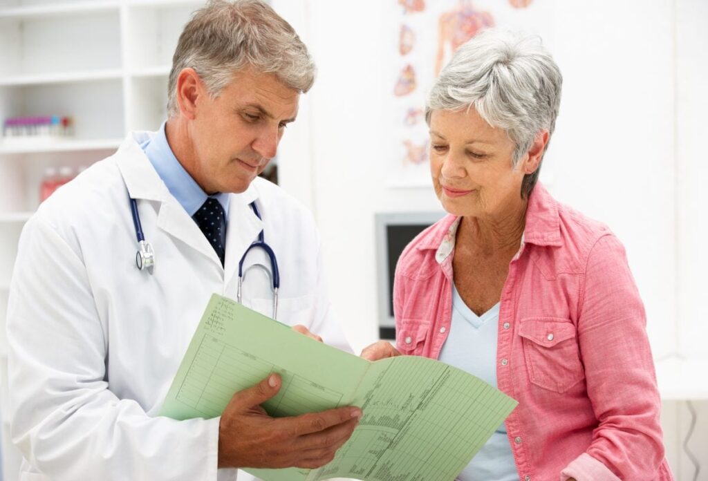 Doctor and elderly female patient going over a test.